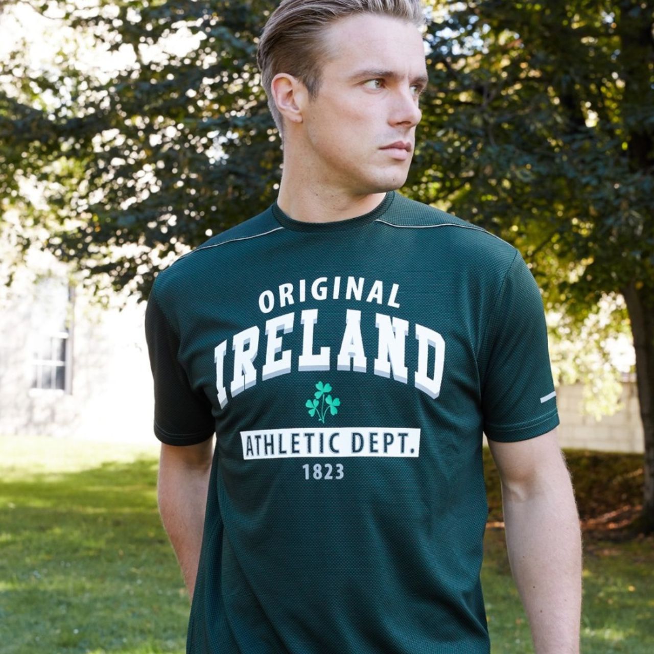 This bottle green performance T-shirt is part of the Lansdowne Sports Official Collection. Designed in a dry fit waffle performance fabric this shirt enhances breathability and comfort as well as improving hydration and circulation. It features an "Athletic Dept." and shamrock logo making it feel extra sporty.