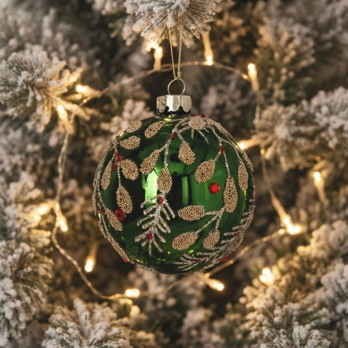 Bring festive elegance to your tree with this stunning Gisela Graham Christmas bauble. Featuring a rich green mirrored finish complemented by delicate beaded gold vine detailing, this ornament captures the essence of sophisticated holiday décor.