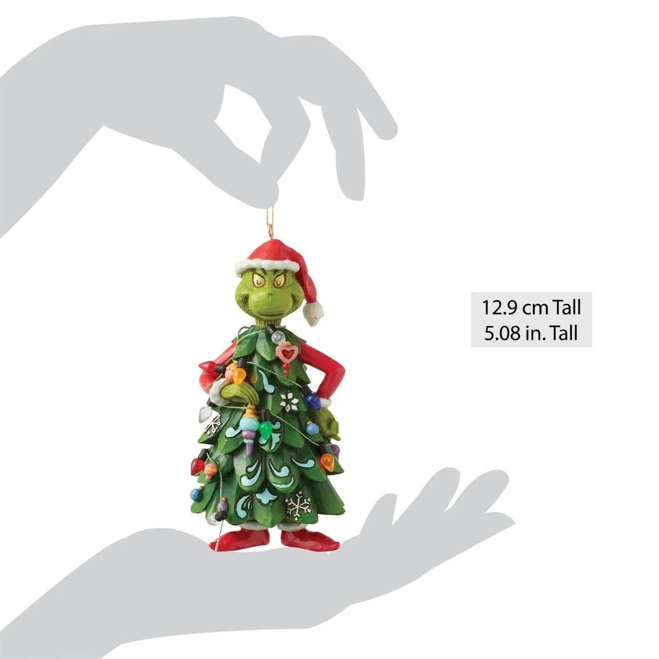 Dressed as a Christmas tree, the Grinch holds an ornament, mischievously decorating himself in this playful Jim Shore design.