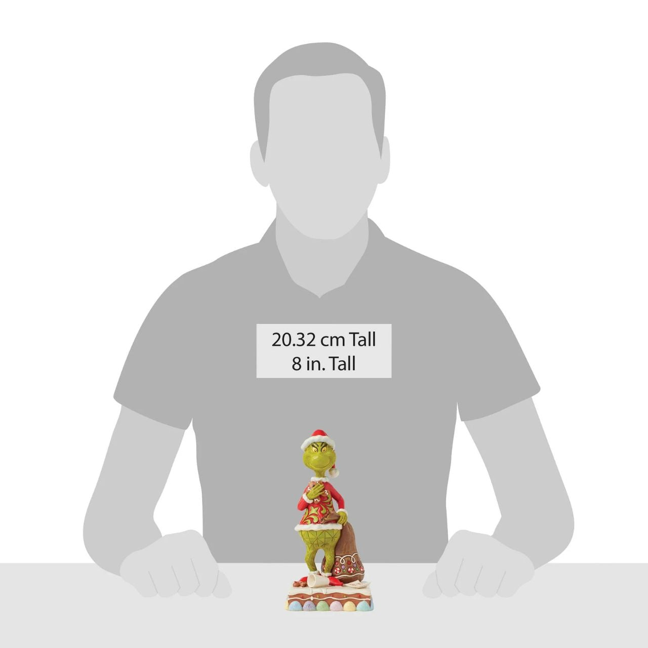 Dressed as Santa with a sack to steal presents, The Grinch gleefully munches on cookies and spills Santa's milk. Adorned with Jim Shore's signature rosemaling and intricate details, this piece brings The Grinch's playfully sinister spirit to life.