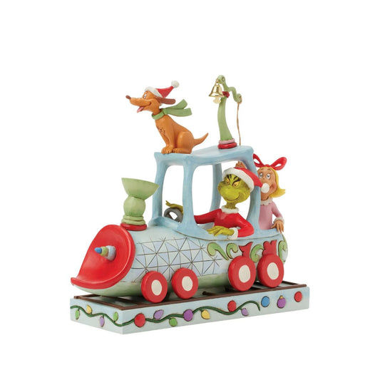 All aboard the Grinchy Express. In this charming Jim Shore creation, The Grinch steers a train engine adorned with delightful floral rosemaling. Max rides on top while Cindy Lou rings a real bell, bringing Seuss's classic tale to life with sound.