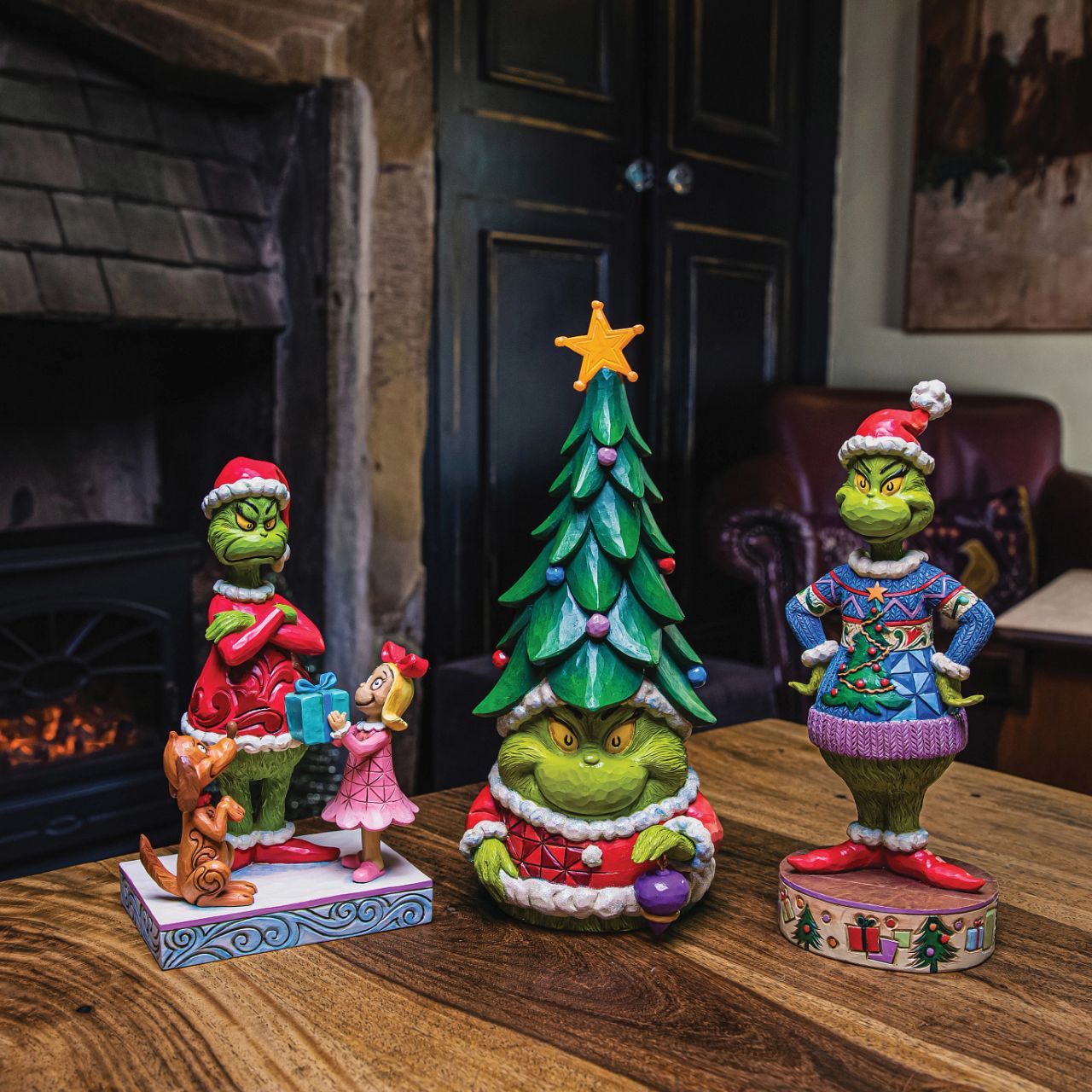 Grinch Wearing Ugly Sweater Figurine  The Grinch shows his love for a Christmas jumper in this figurine. Designed by award winning folk artist Jim Shore his jumper is intricately designed with so much detail it looks almost real.
