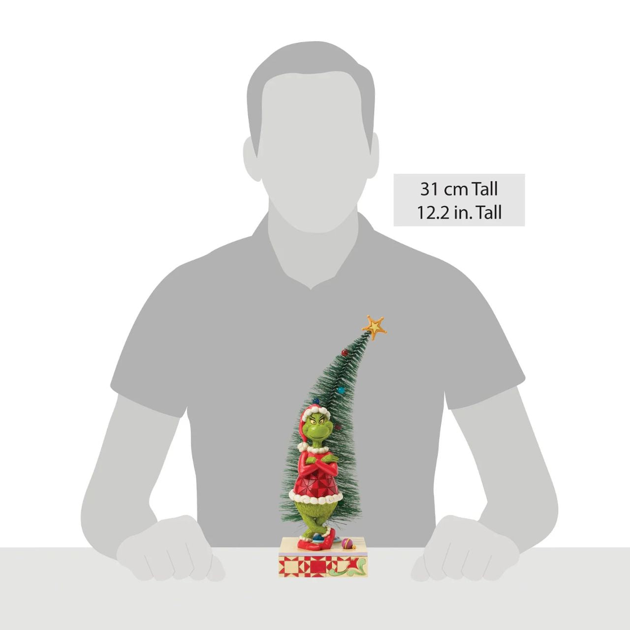 This playful Jim Shore design features The Grinch, arms crossed with a smirk, exuding snarky attitude as he stands beside a beautiful sisal tree with vibrant ball ornaments. Bring mischief home with Jim Shore's intricate detailing and rich colours.