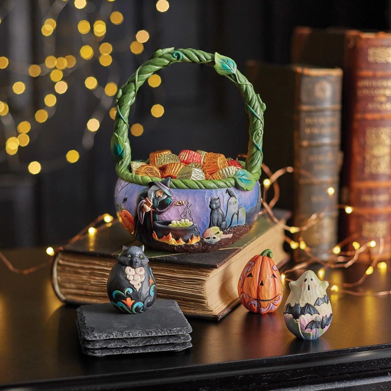 Heartwood Creek Halloween Basket Figurine  Beautifully hand-painted and crafted from high-quality stone resin with intricate styling and attention to detail. This intricate Jim Shore Halloween basket features two spooky sides. A witch brews a potion in a graveyard on one half while a Jack-o-lantern smiles on the other.