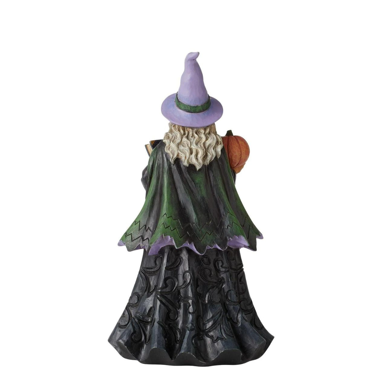 Friendly Witch Figurine Heartwood Creek by Jim Shore  Handcrafted in breathtaking detail, this beautiful Friendly Witch Figurine is beautifully decorated in Jim Shore's subtle combination of traditional quilt. This spellbinding Jim Shore sorcerer holds a jack-o-lantern and potions book in her ghoulish grip.