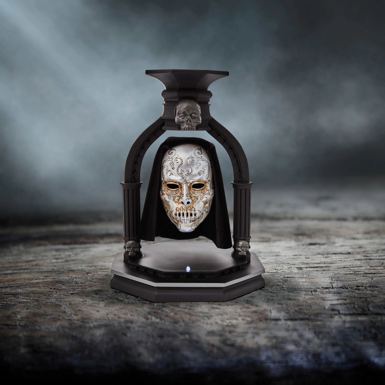NEW and exclusively from Enesco is the Bellatrix Lestrange Levitating Death Eater Mask. This piece works using polarized magnets to hold the mask in place, floating in mid air with an LED light indicating when the magnet is activated.
