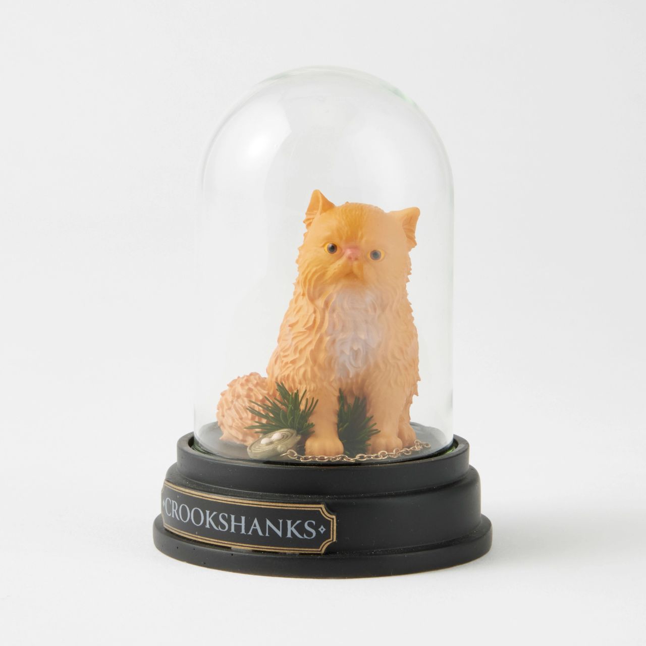 Capturing the essence of Hermione's beloved ginger-coloured feline friend, this intricately detailed sculpted and hand-painted miniature figure presented under a clear glass dome