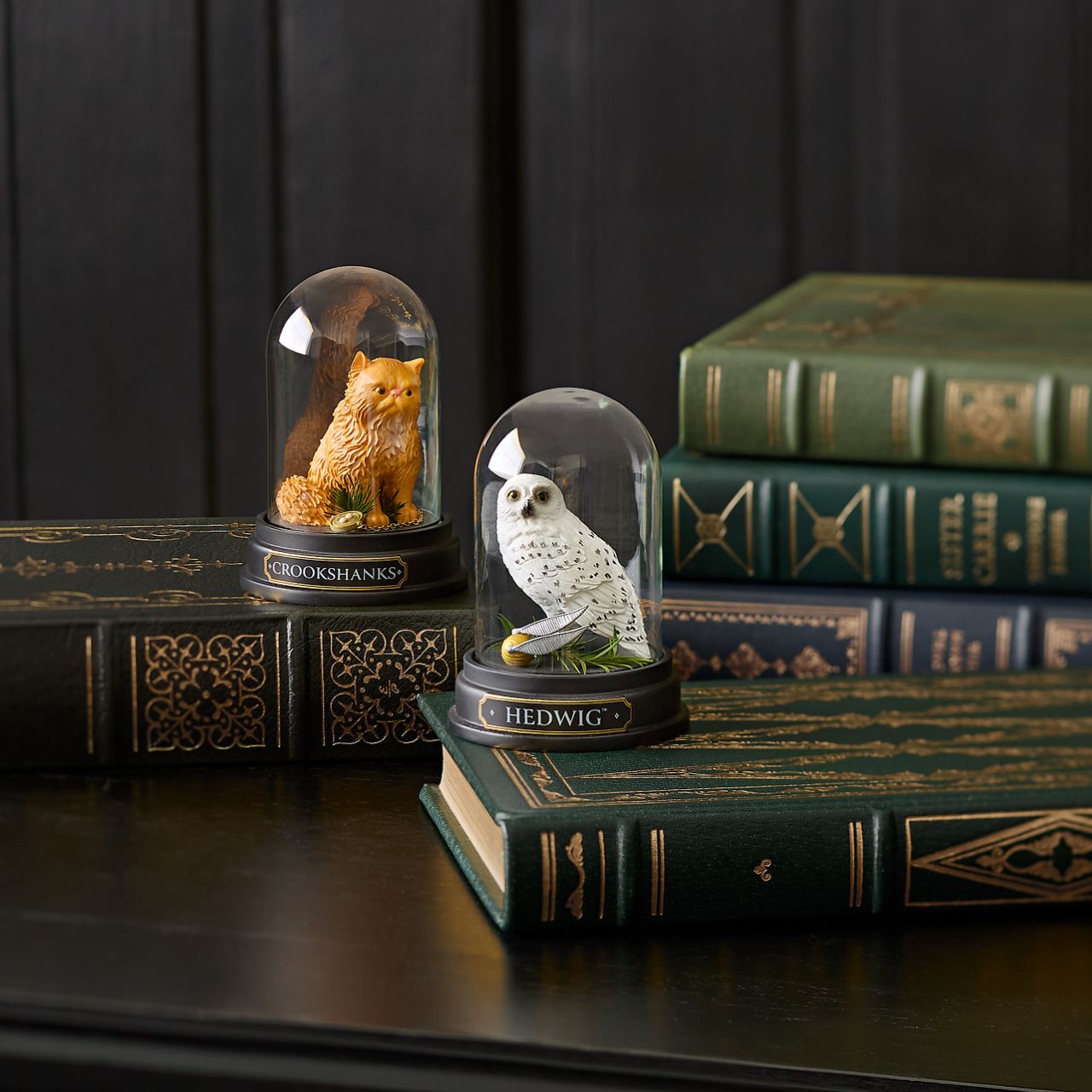 Capturing the essence of Hermione's beloved ginger-coloured feline friend, this intricately detailed sculpted and hand-painted miniature figure presented under a clear glass dome