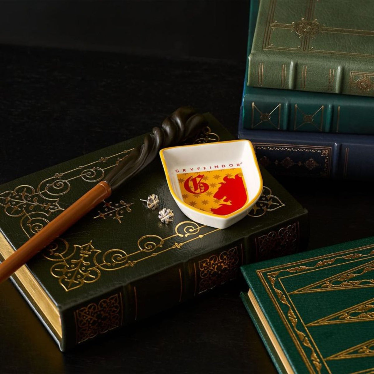 Show your house pride with the Gryffindor Trinket Dish from the Wizarding World of Harry Potter collection. Made from high quality cast stone and finished with a decal, this will be a must-have piece for any collectible of Magical memorabilia.