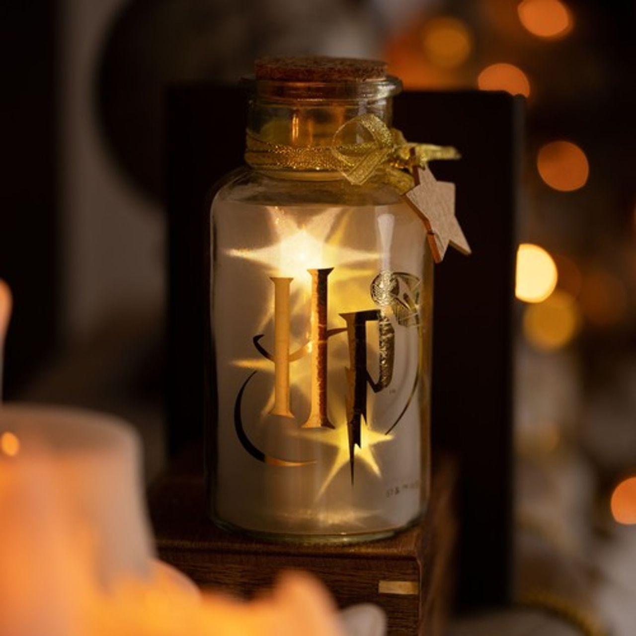 Harry Potter LED Light Up Glass Jar - Hogwarts Crest  Lumos maxima! Light up your home this Christmas with this Hogwarts LED glass jar light. With a stunning print, this fun accessory is sure to add a touch of magic to your home this Christmas.