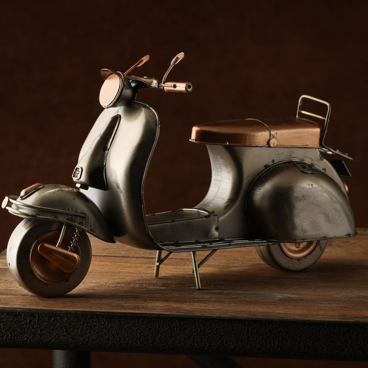 Add a dash of retro charm to your décor with the Harvey Makin Ornament - Scooter. Crafted with attention to detail, this vintage-style scooter reflects an era of classic design and style.