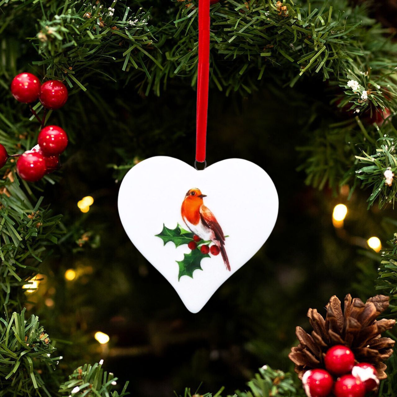 Elevate your holiday décor with the Gisela Graham Robin on Holly Christmas Hanging Ornament. This finely crafted piece features a delicate robin perched amidst vibrant holly leaves and berries, adding a touch of natural elegance to your Christmas tree.