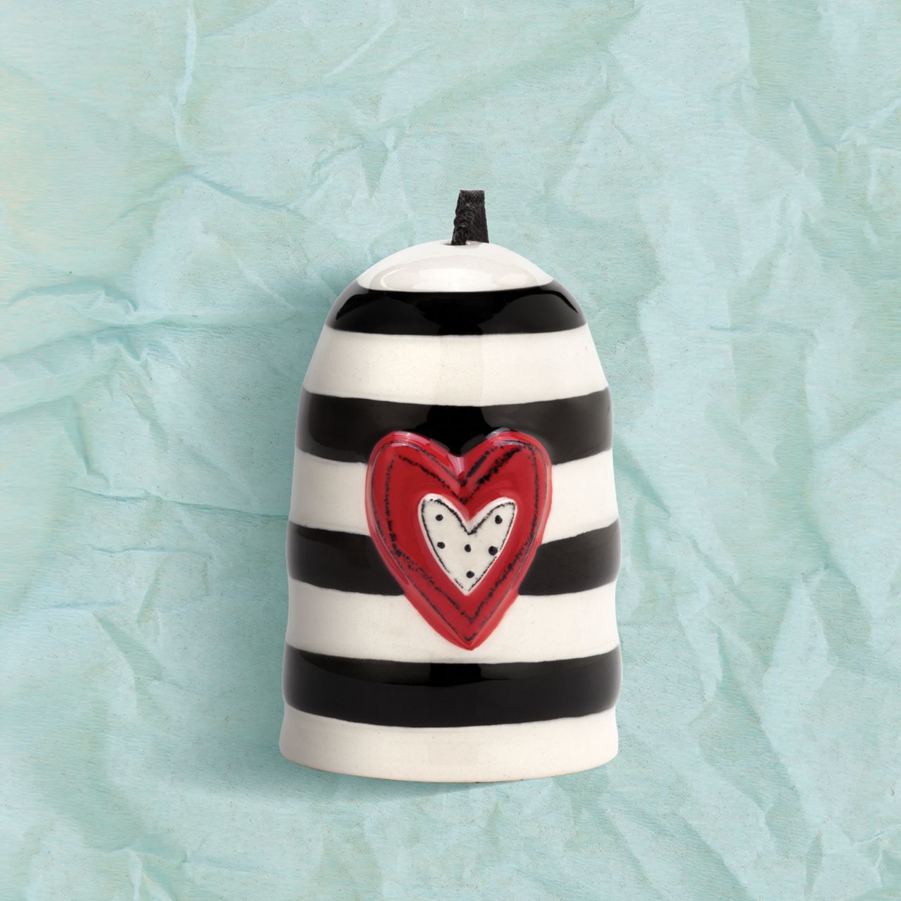 Heartful Home Bell - Love by Demdaco  Add a whimsical, happy touch to your home with Tracy Pesche's uplifting ceramic art. Her hand-painted Heartful Home Bell - Love is a bright token of love that makes a pleasing, sing-song jingle whenever you desire. It is white with an array of beautiful black stripes and a bold red heart with a polka dot centre. It bears the simple word, "Love."