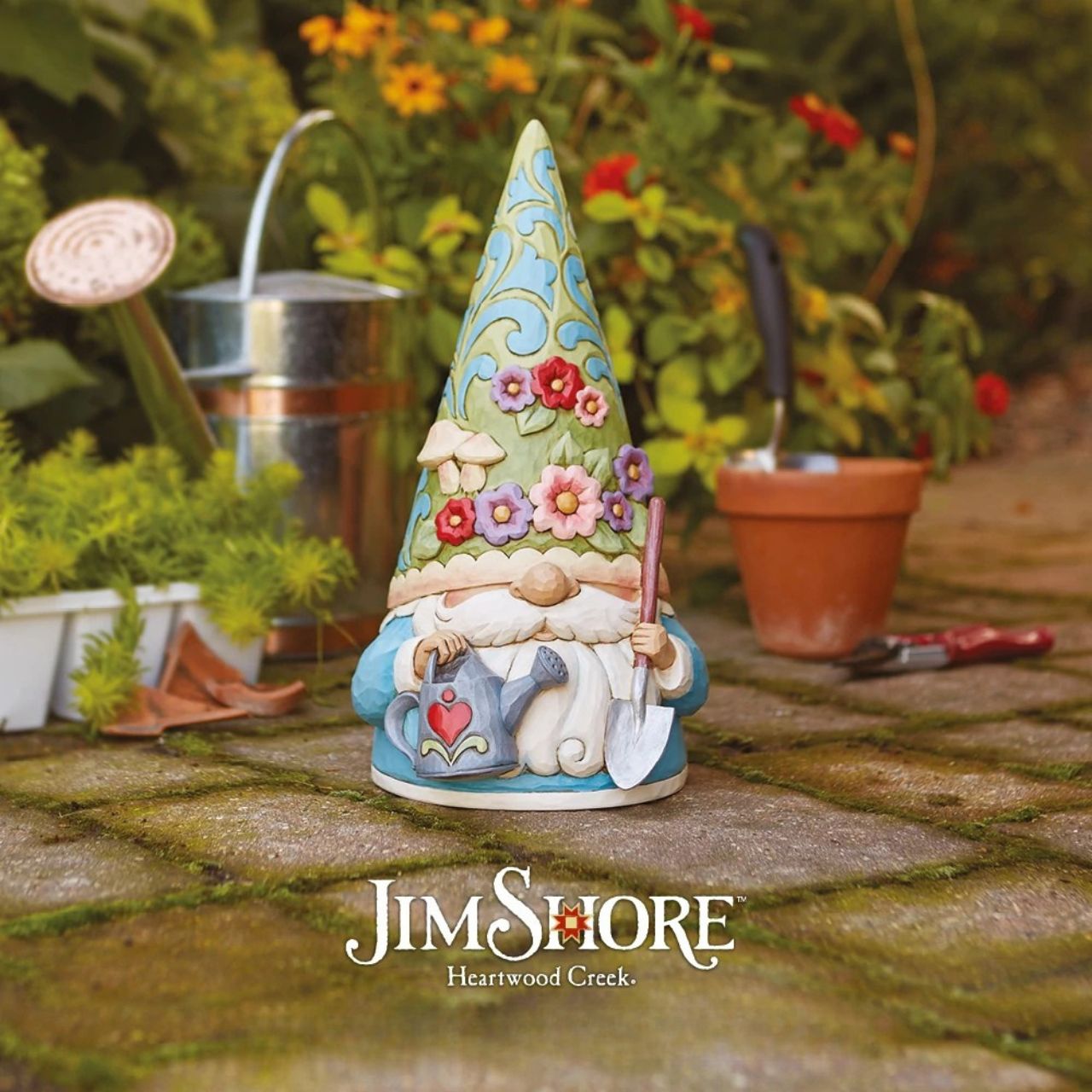 "Bloom and Grow" For centuries, gnomes have been symbols of good luck, they are thought to provide protection with their delightful charm. This Jim Shore gnome is ready to garden, and wears a flower and fungi patterned hat while holding a watering can and shovel.