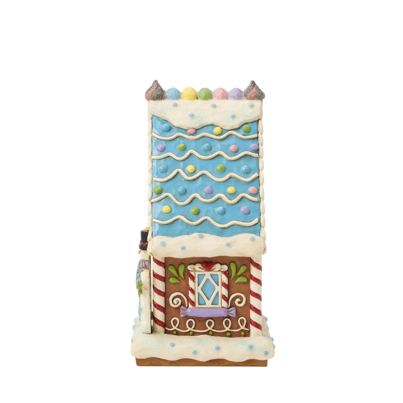 This enchanting Jim Shore LED light-up sweet shop invites you into a festive gingerbread house with colourful icing, cookies, and candy. Glowing warmly, it promises a world of delicious treats and holiday cheer, making it a delightful centerpiece.