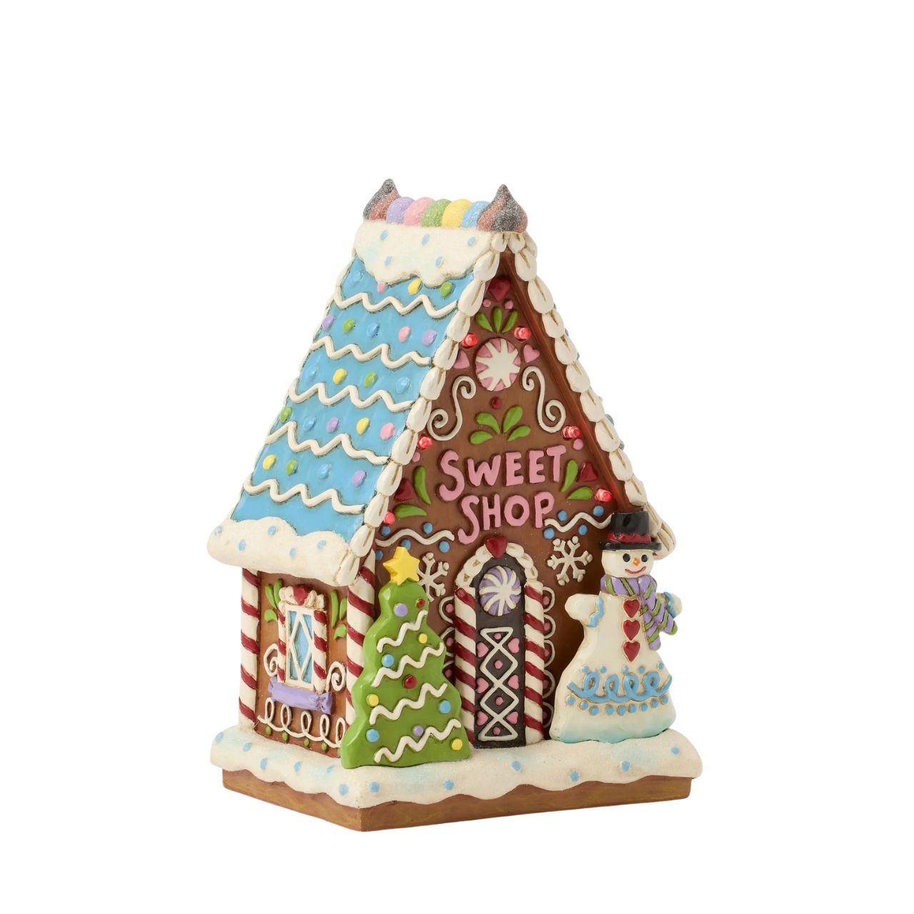 This enchanting Jim Shore LED light-up sweet shop invites you into a festive gingerbread house with colourful icing, cookies, and candy. Glowing warmly, it promises a world of delicious treats and holiday cheer, making it a delightful centerpiece.