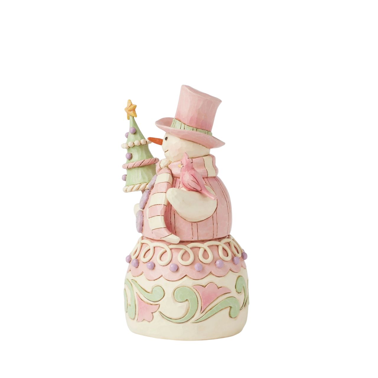 This whimsical Heartwood Sweets pastel pink snowman by Jim Shore radiates charm with his rosemaling patterns, sprinkles, and icing details, embodying the essence of holiday cheer. He lovingly holds a decorated tree and a cardinal.