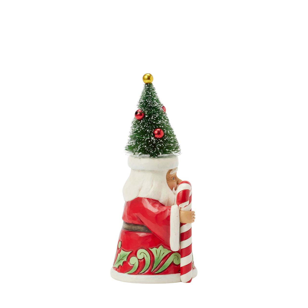 This pint-sized Jim Shore Santa, sporting a whimsical sisal tree decorated as a hat, brings joy with a cheerful smile and festive demeanour. Carrying a candy cane, his cloak is adorned with holly patterning as he embodies the spirit of Christmas.