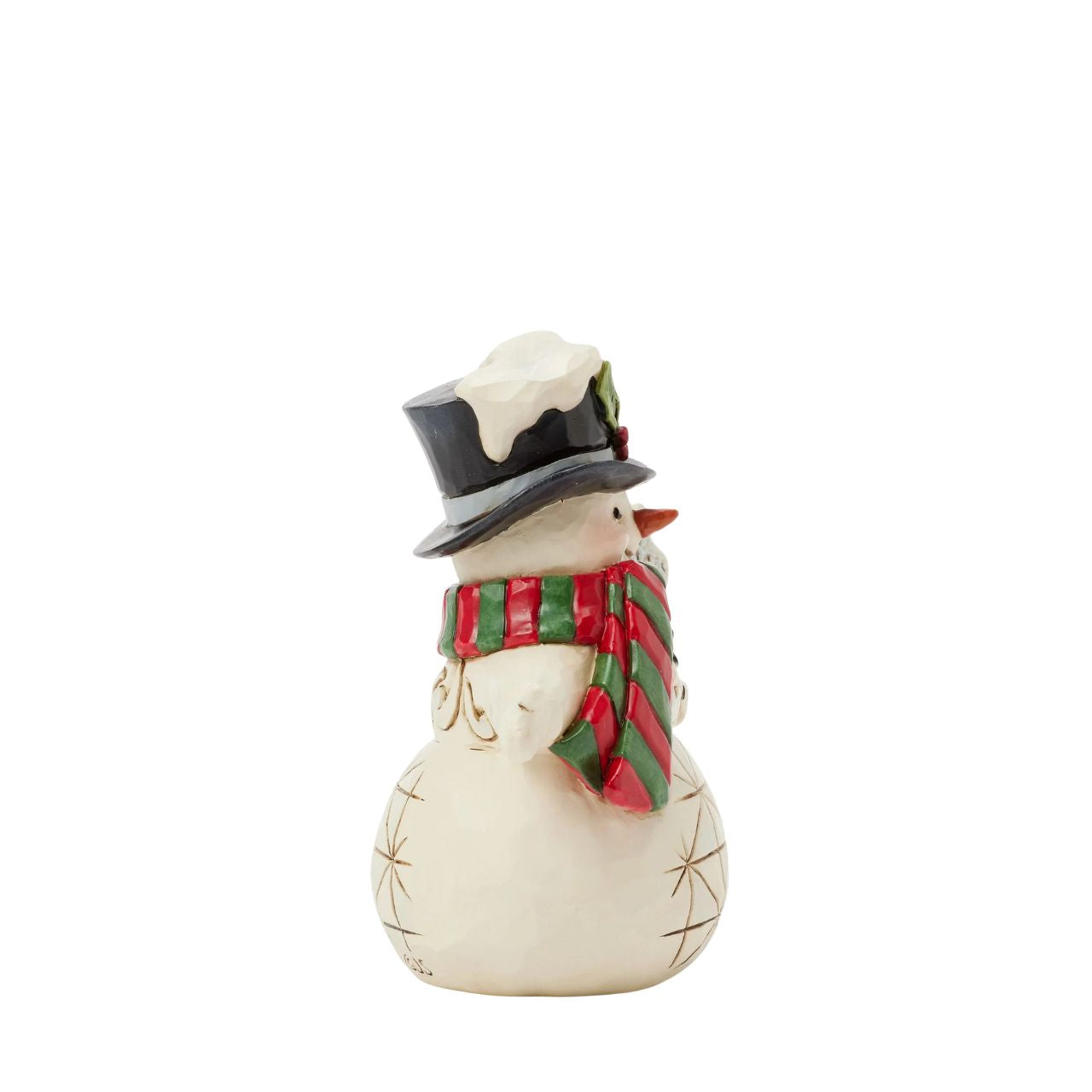 This delightful Jim Shore miniature snowman brings holiday cheer with a snowflake-topped cane and a festive red and green. His charming top hat, adorned with holly and dusted with snow, makes him a joyful addition to your holiday home.