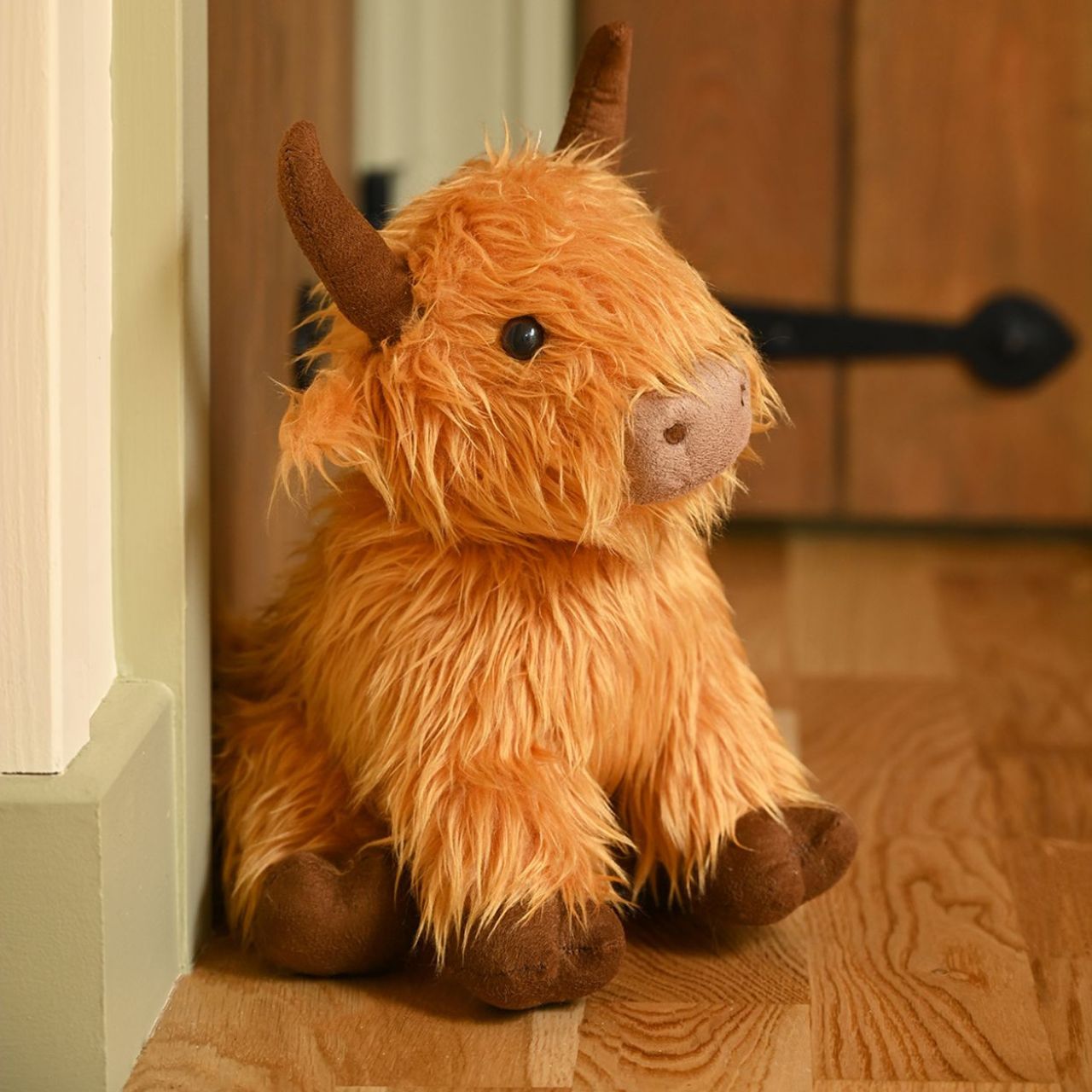Featuring a plush, furry exterior and prominent horns, this Highland Cow Doorstop captures the iconic look of these shaggy bovines. Keep doors propped open in style.