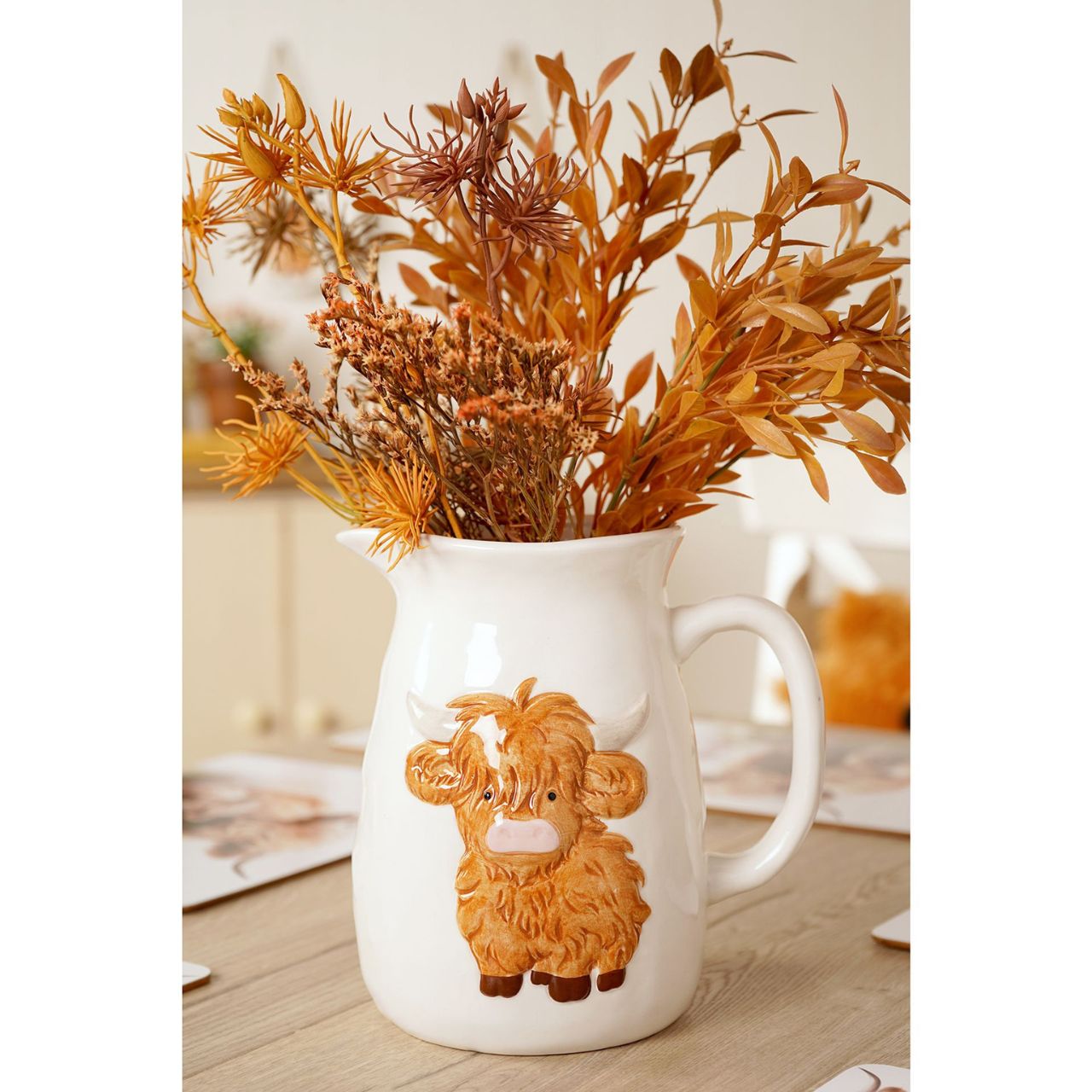 This ceramic jug features a sweet illustration of a highland cow set against a soft, neutral background - bringing a smile to every pour. Ideal for serving milk, cream, or even displaying fresh flowers.