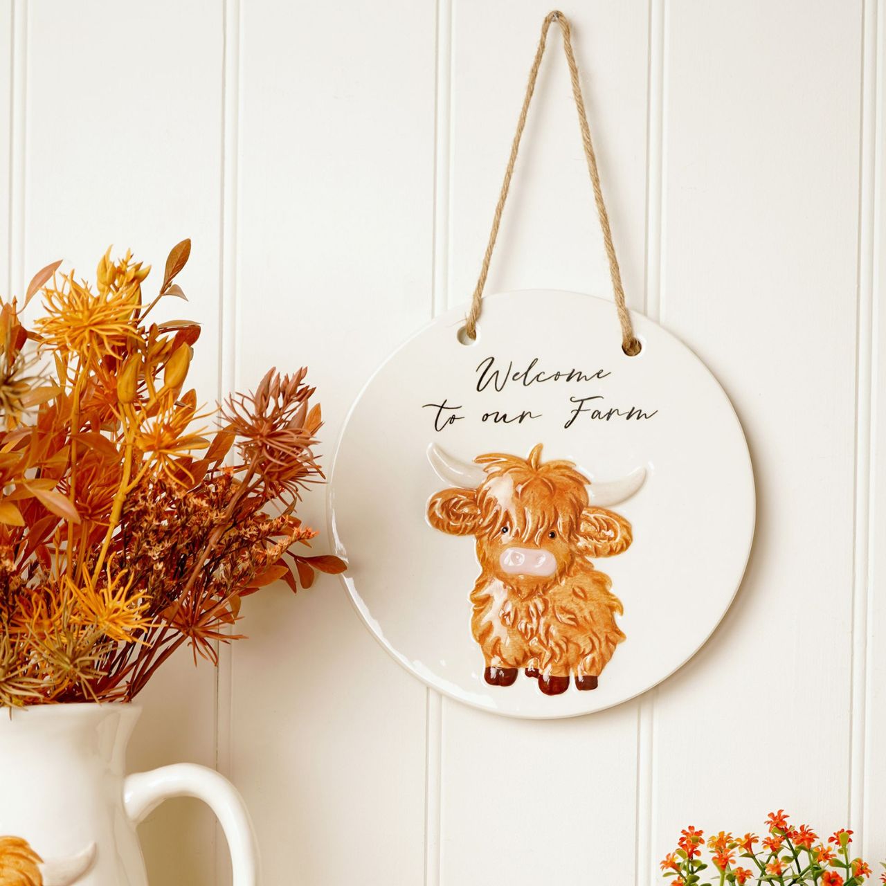 Featuring an adorable highland cow illustration and the friendly message "Welcome to our Farm," this ceramic sign is perfect for greeting visitors with a smile.