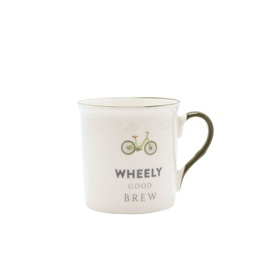 A white ceramic mug with a bicycle illustration and the text "Wheely Good Brew" printed on it.