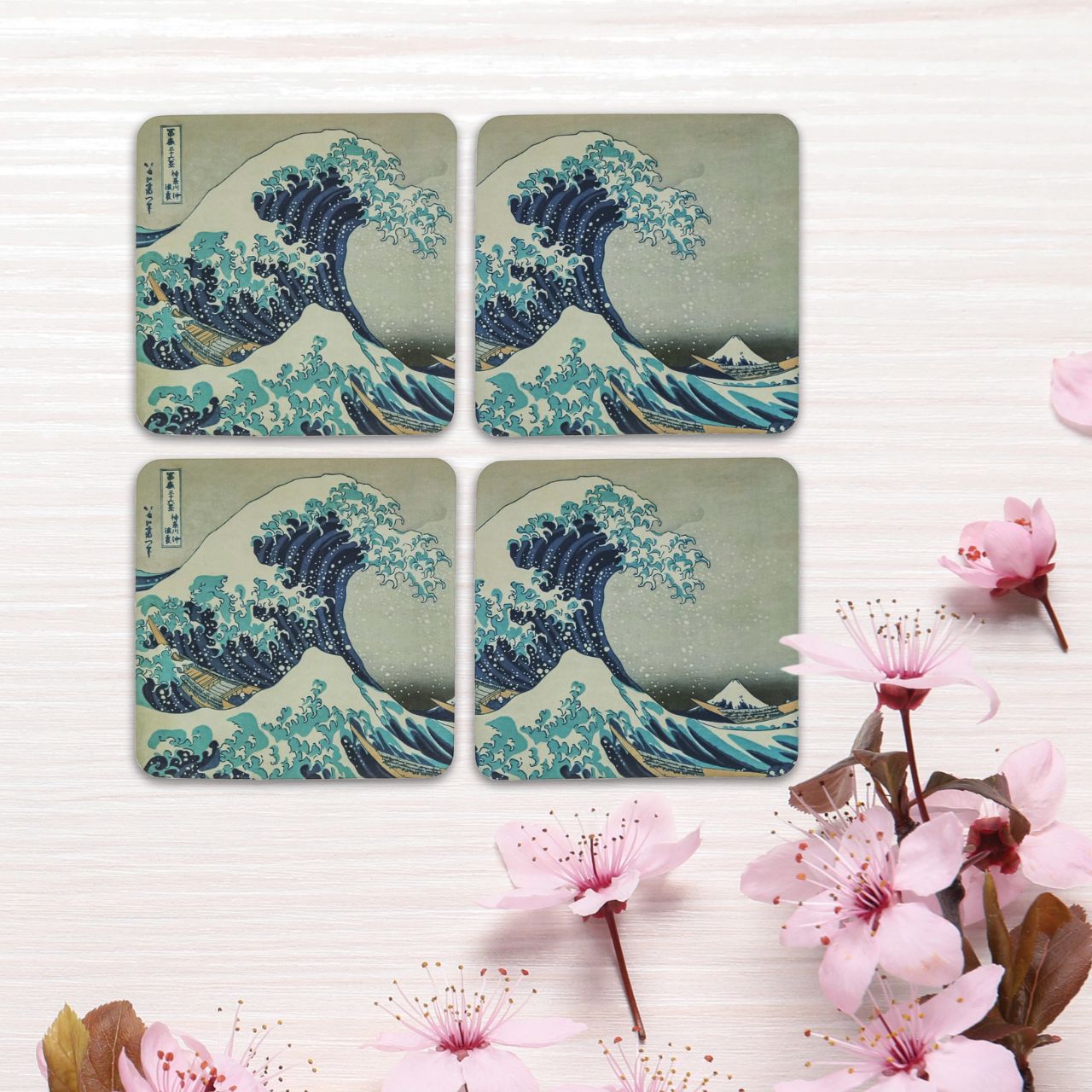Set of 4 assorted coasters stored in a pretty box. Based on the famous painting "Great Wave" by Hokusai.