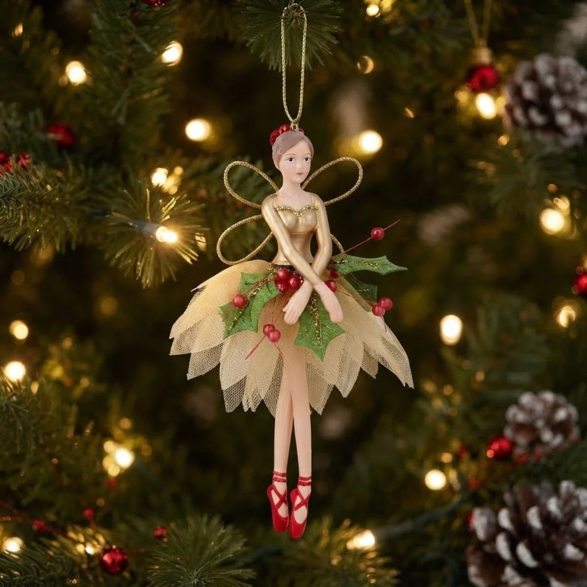 Enhance your holiday decorations with the Gisela Graham Red Green Gold Holly Fairy Hanging Christmas Ornament. Made with festive red, green, and gold colours, this hanging decoration features intricate holly fairy detailing that adds a touch of whimsy to your Christmas tree or garland. A perfect addition to your holiday collection.