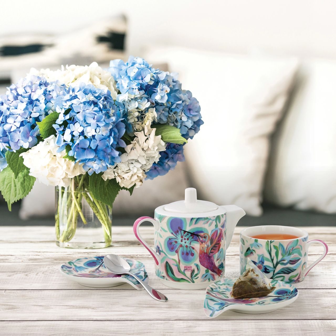 Small ceramic teapot with matching cup for 1 person. Perfect for drinking tea alone, and making this moment of relaxation your little moment to yourself. Original and colourful design by artist Michelle Allen for the Allen Designs collection.