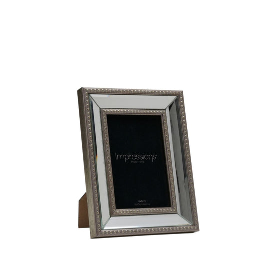 The Impressions Mirror Photo Frame Gold Decorative Border 4" x 6" beautifully displays cherished memories. With an elegant gold border and mirrored background, this frame adds glamour to any photo.