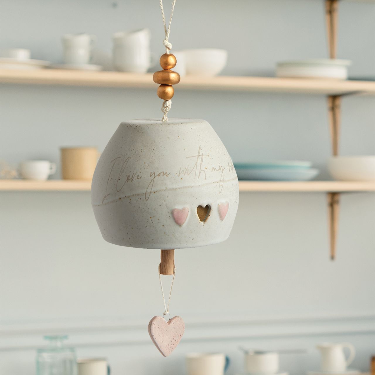 Inspired Bell - Love by Demdaco  Give beauty and relaxation with our Inspired Bells collection, a selection of artisan bells in soft, serene colours with soothing, gentle rings bearing sentiments of faith and love. Our Inspired Bell - Love is a ceramic indoor/outdoor bell in white with a heart pull and little heart-shaped cutouts. The sentiment on the bell reads, "I love you with my whole heart."