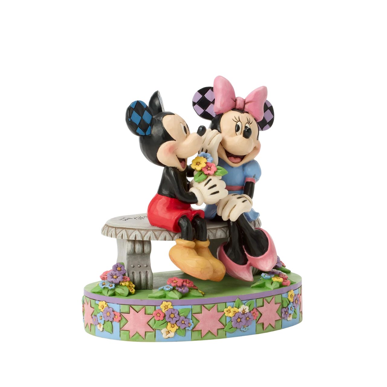 Mickey and Minnie share a sweet moment on a park bench in this romantic Jim Shore scene. Surrounded by colourful flowers and Jim's rosemaling and quilt patterns, Mickey presents Minnie with a fresh bouquet as she blushes.