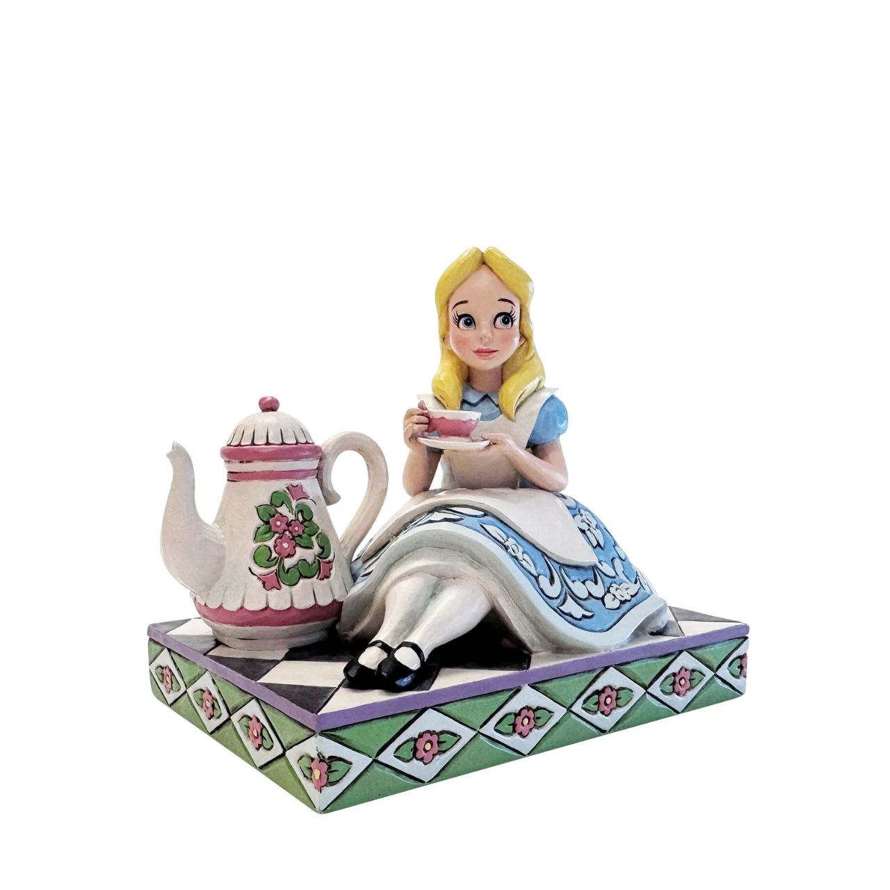 Alice sips beside a giant teapot in this whimsical Jim Shore creation. Inspired by Alice in Wonderland, this charming scene celebrates the imagination, playfulness, and magic of Disney's most curious tea party.