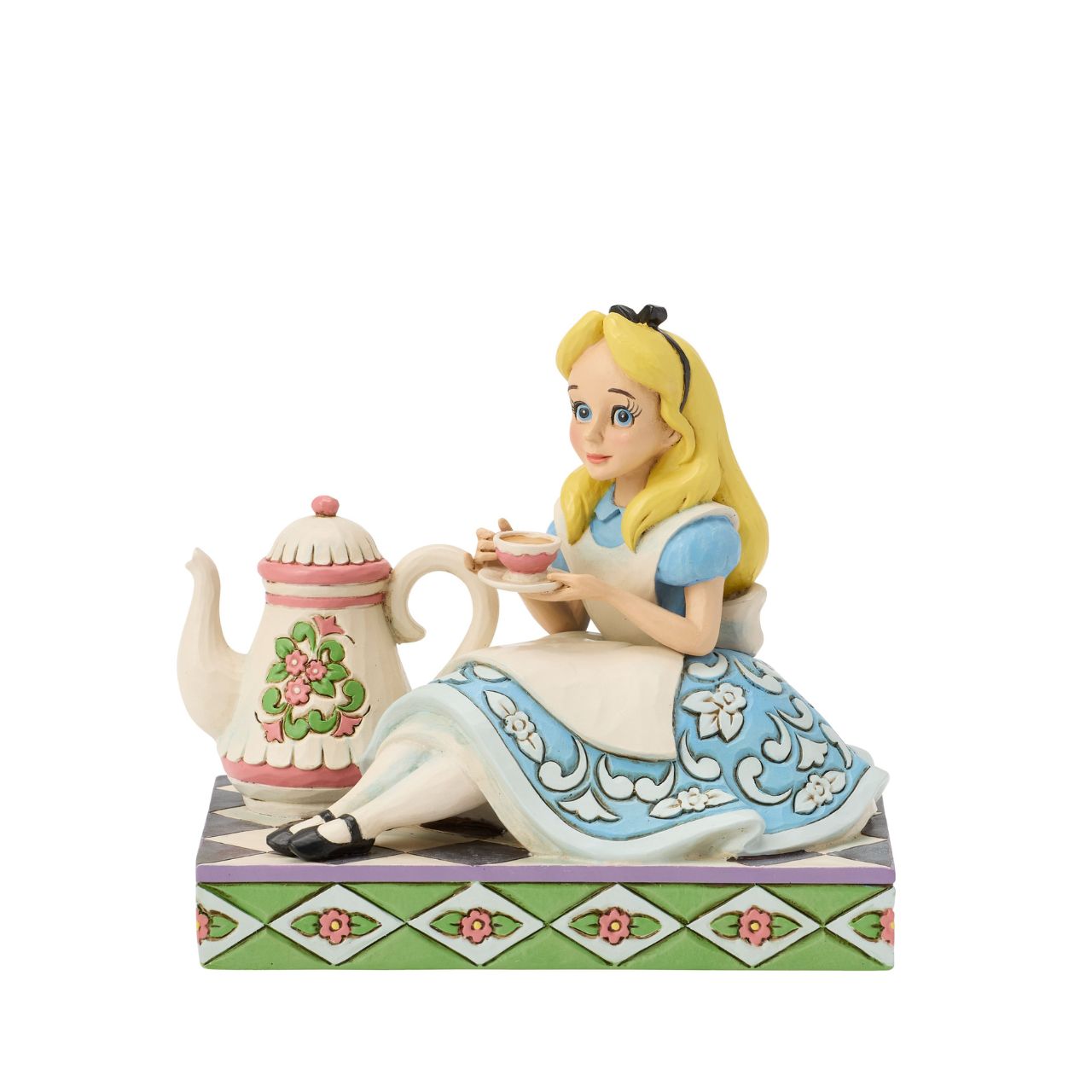 Alice sips beside a giant teapot in this whimsical Jim Shore creation. Inspired by Alice in Wonderland, this charming scene celebrates the imagination, playfulness, and magic of Disney's most curious tea party.