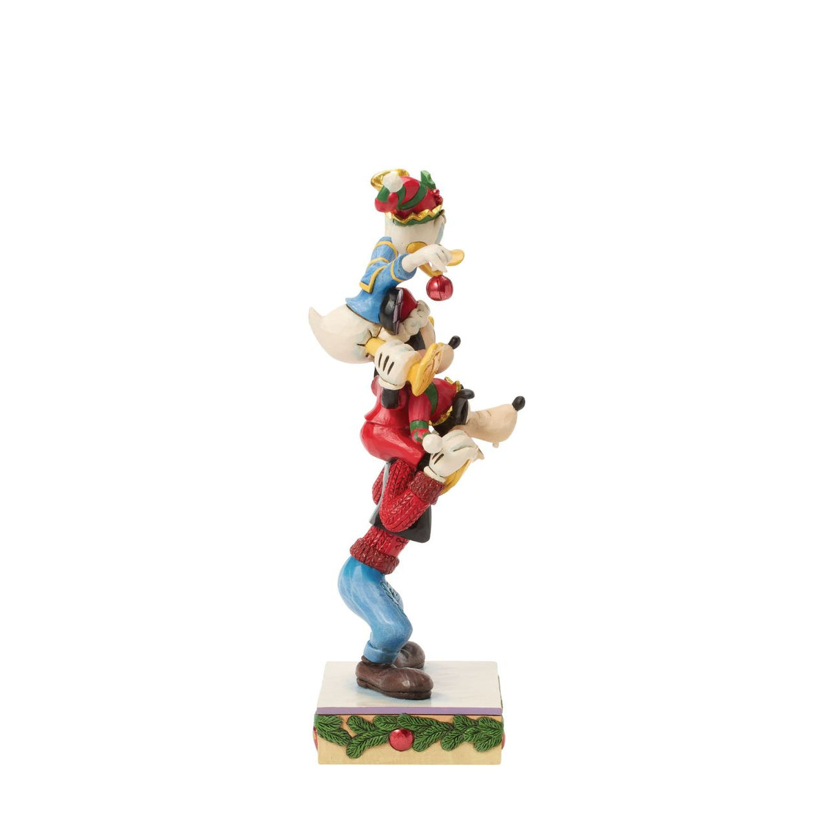 Jim Shore captures Disney's beloved trio in a joyful tower of friendship. With Donald Duck balanced atop Mickey Mouse and Goofy holding steady, this colourful design celebrates laughter, teamwork, and the timeless magic of Disney pals.