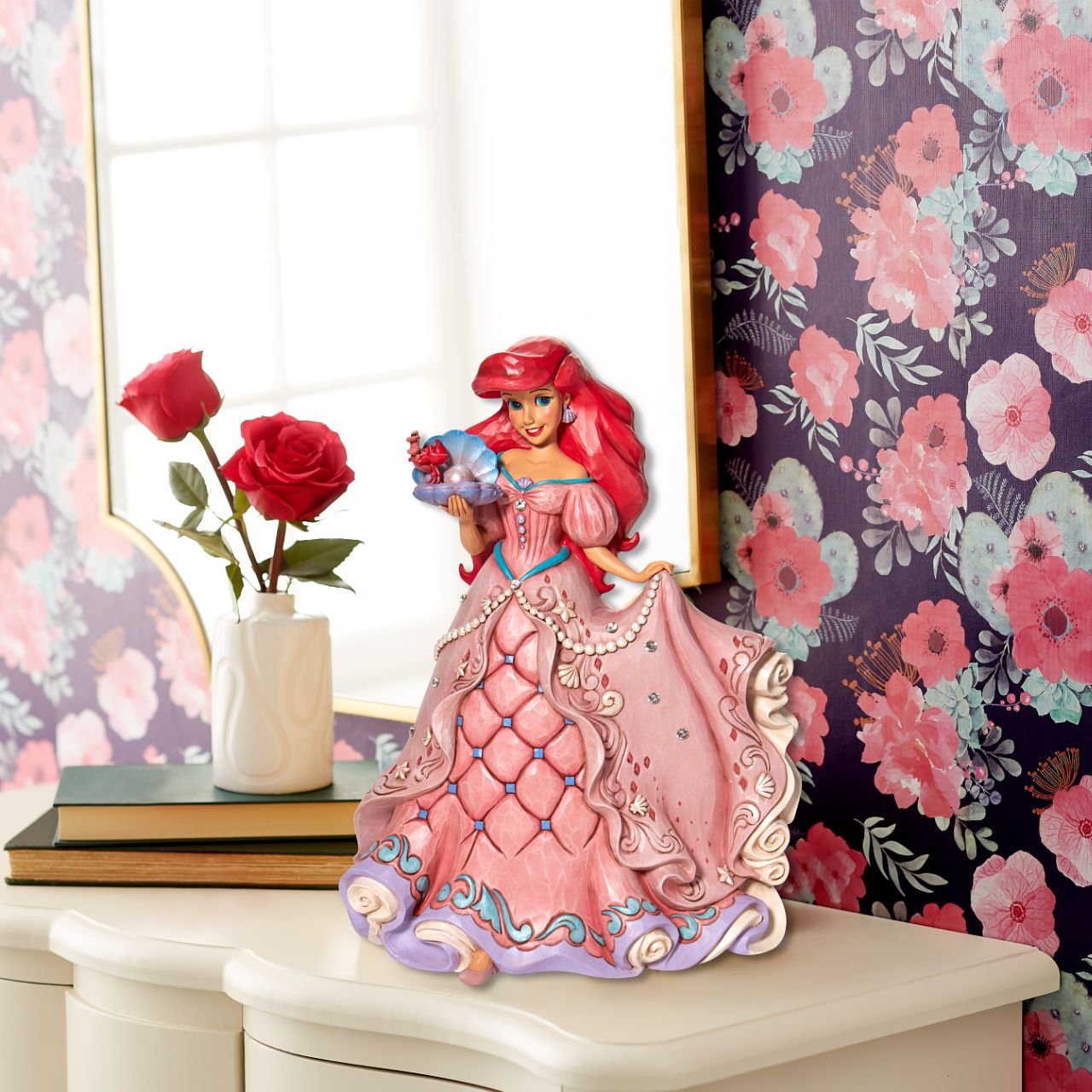 "A Precious Pearl" Second in the Series of Deluxe Figurines, The Enchanted Princess Series, is this striking 40cm Ariel Figurine. Thanks to the magic of a mysterious sea witch, Ariel The Little Mermaid, grows legs to walk on land. This sparkling Jim Shore figurine features the princess at her prettiest, her gown fitted with shells and jewels, she holds an oyster with a pearl.