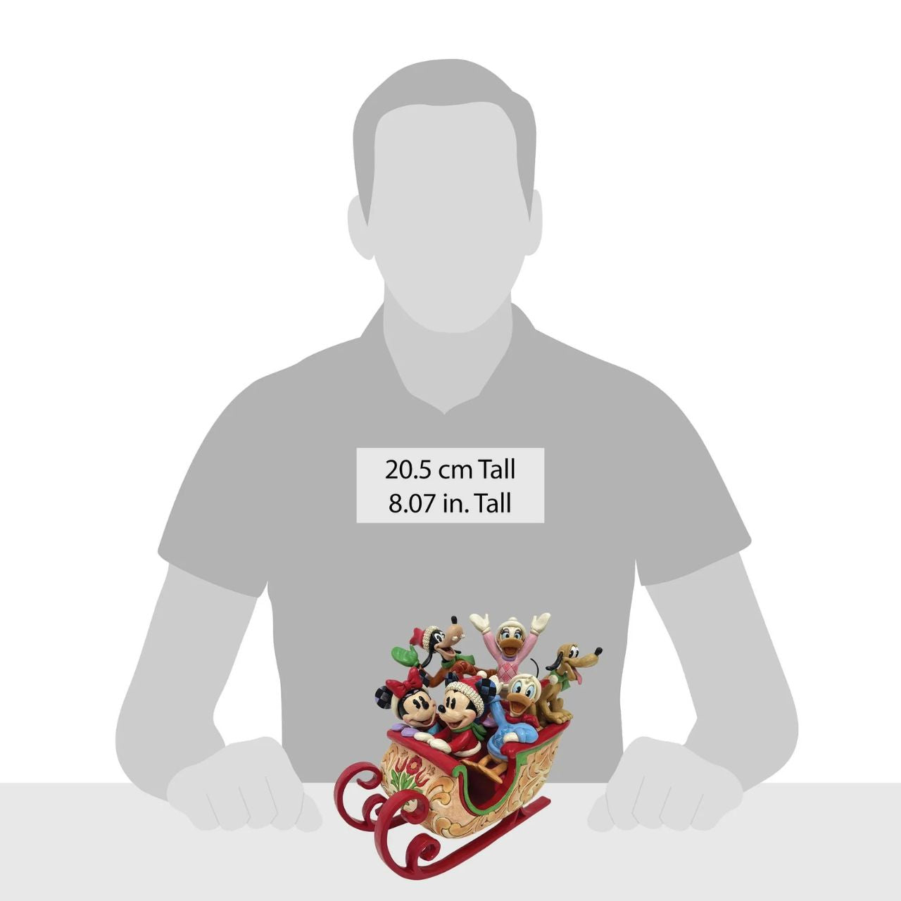 Celebrate the season with Jim Shore's enchanting Christmas sleigh ride featuring Mickey, Minnie, Donald, Daisy, Goofy, and Pluto bundled together in a beautifully crafted sleigh. Decorated with vibrant rosemaling patterns and gleaming metal runners.