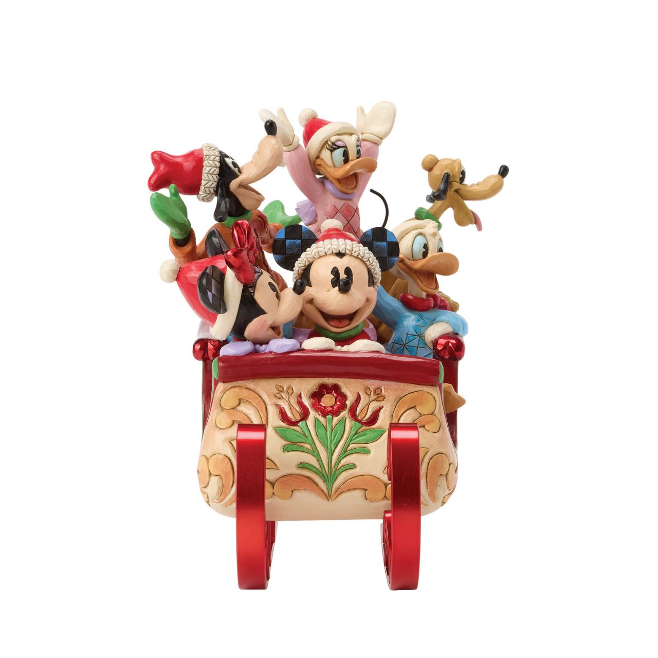 Celebrate the season with Jim Shore's enchanting Christmas sleigh ride featuring Mickey, Minnie, Donald, Daisy, Goofy, and Pluto bundled together in a beautifully crafted sleigh. Decorated with vibrant rosemaling patterns and gleaming metal runners.