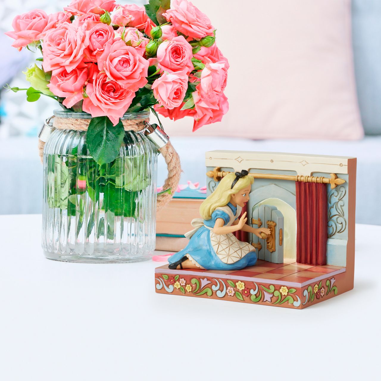 Alice eagerly opens the door to Wonderland, twisting the smiling doorknob while the curtains draw back to reveal the enchanting realm beyond. With inviting LED lights, this captivating Jim Shore scene captures the curiosity of Alice's adventure.