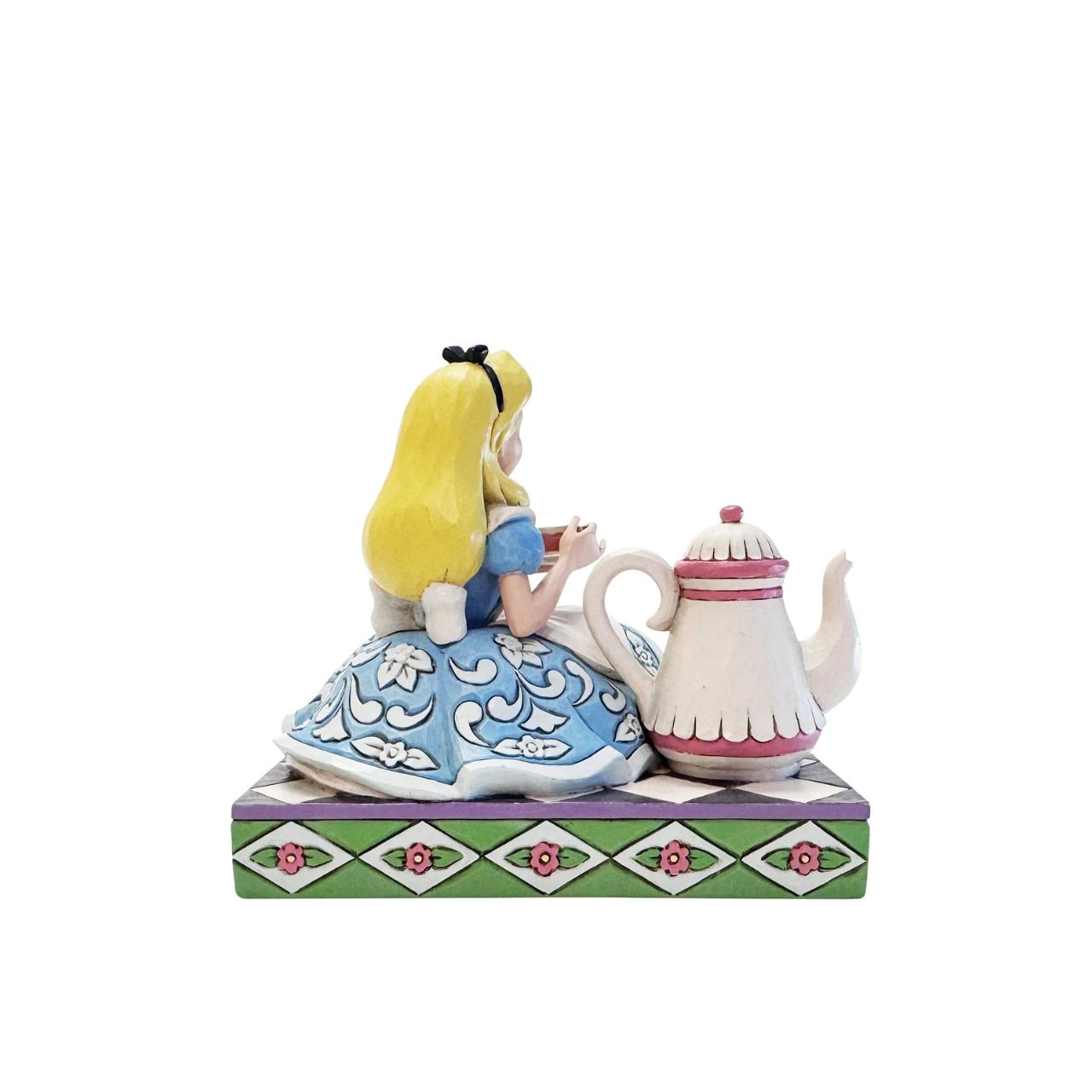 Alice sips beside a giant teapot in this whimsical Jim Shore creation. Inspired by Alice in Wonderland, this charming scene celebrates the imagination, playfulness, and magic of Disney's most curious tea party.