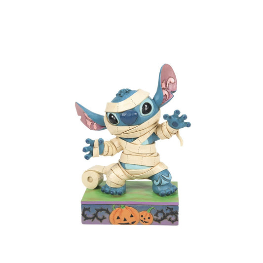 Stitch is ready for Halloween in his cute Mummy costume. The perfect spooky gift for any Disney Traditions fan. Designed by Jim Shore and hand painted.
