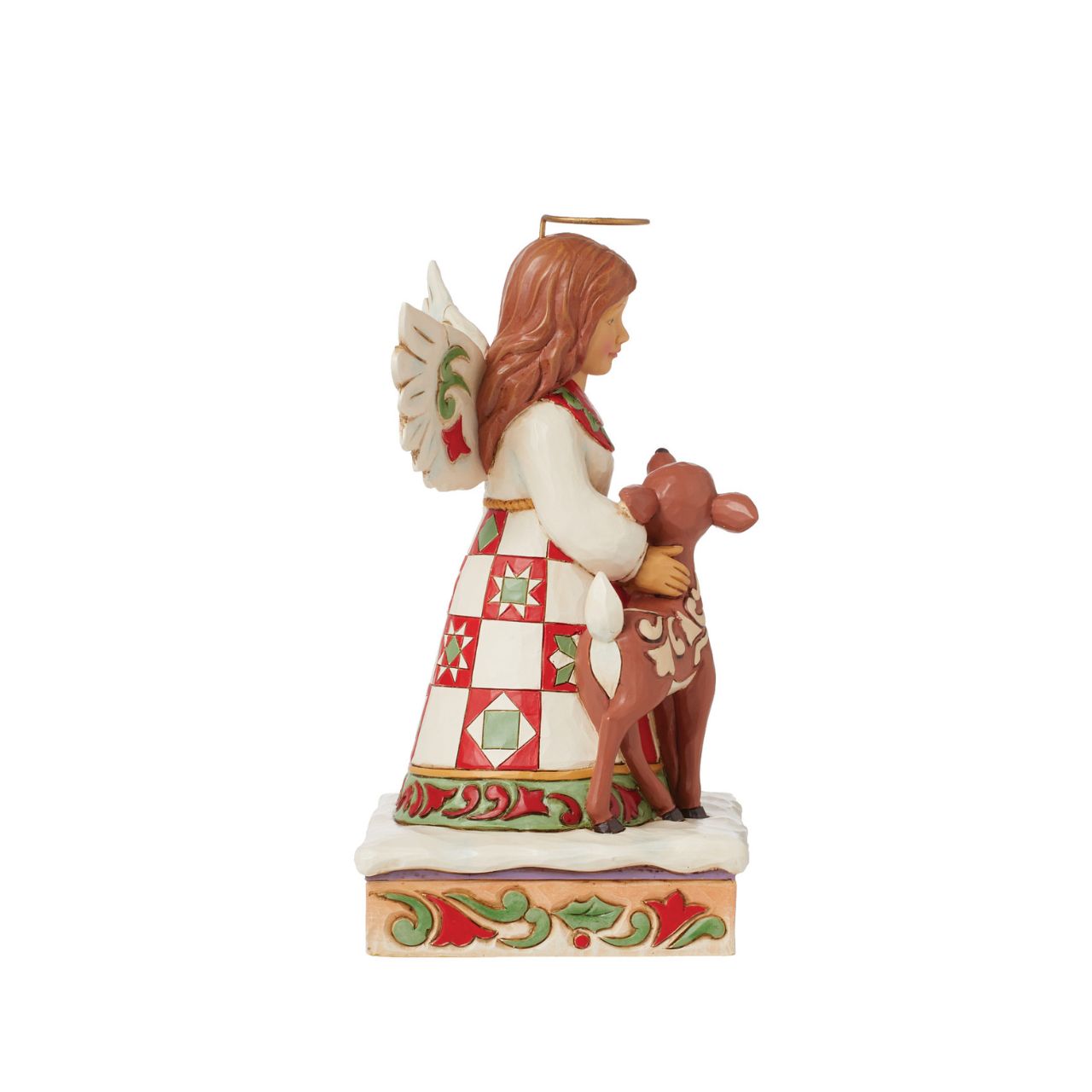 On a stage of flowers, a hallowed angel wears a red and green patchwork patterned dress with a smile. She pats a gentle fawn with a rosemaling pattern. The sweet Jim Shore modelled pair celebrate the simplicity of friendship and miracle of nature.