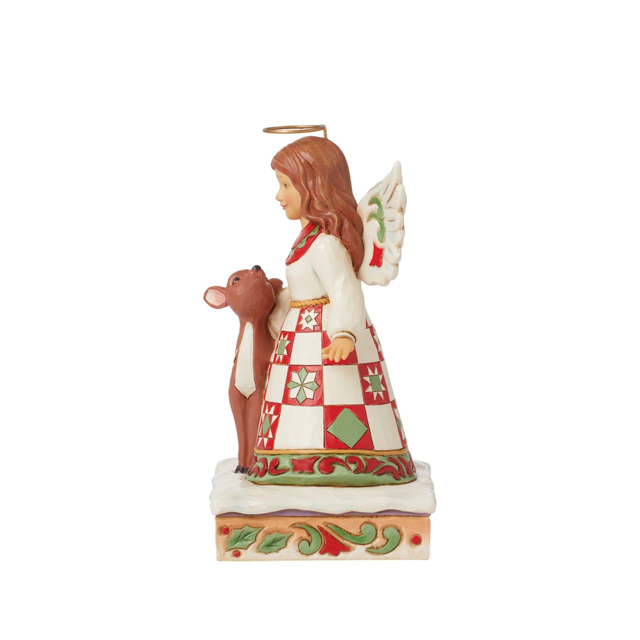 On a stage of flowers, a hallowed angel wears a red and green patchwork patterned dress with a smile. She pats a gentle fawn with a rosemaling pattern. The sweet Jim Shore modelled pair celebrate the simplicity of friendship and miracle of nature.