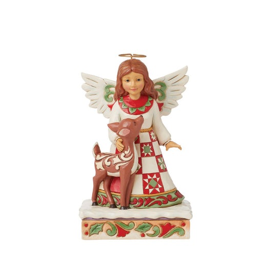 On a stage of flowers, a hallowed angel wears a red and green patchwork patterned dress with a smile. She pats a gentle fawn with a rosemaling pattern. The sweet Jim Shore modelled pair celebrate the simplicity of friendship and miracle of nature.