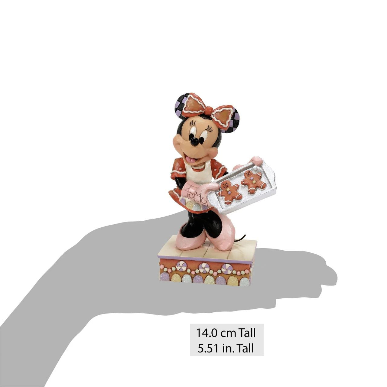 Dressed in a delightful gingerbread-inspired dress and bow, Minnie Mouse shares freshly baked cookies in this heart-warming Jim Shore scene.