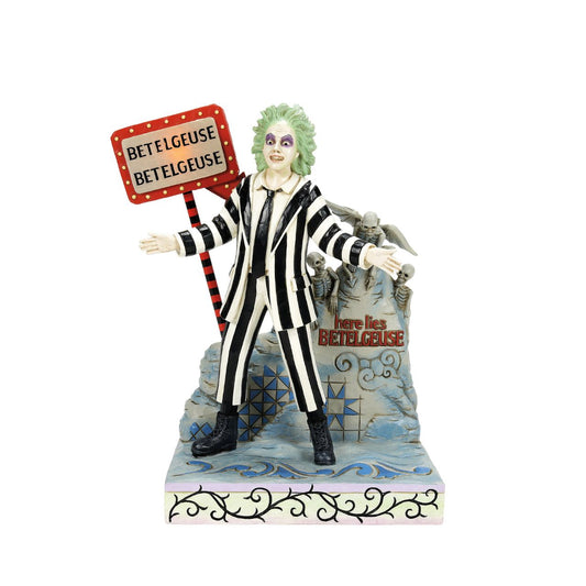 Beetlejuice, Beetlejuice, Beetlejuice... He's here. The iconic bio-exorcist from the 1988 Tim Burton film has arrived and this time, he has a Jim Shore twist. Crafted from high quality cast stone and hand-painted, this light up figurine features the main (dead) man himself, atop his grave with an illuminated "Vegas" style LED sign letting all know who he is.