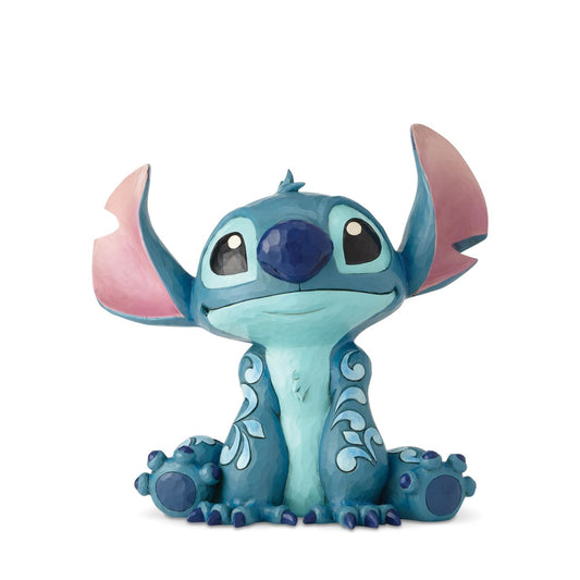 Disney Traditions Big Trouble Stitch Statement Figurine  It's hard to believe this sweet face could be behind so much chaos| Stitch, the troublesome alien from Disney's "Lilo and Stitch" strikes an innocent pose in this handcrafted design, sculpted from cast stone and hand-painted with whimsical folk-art details.