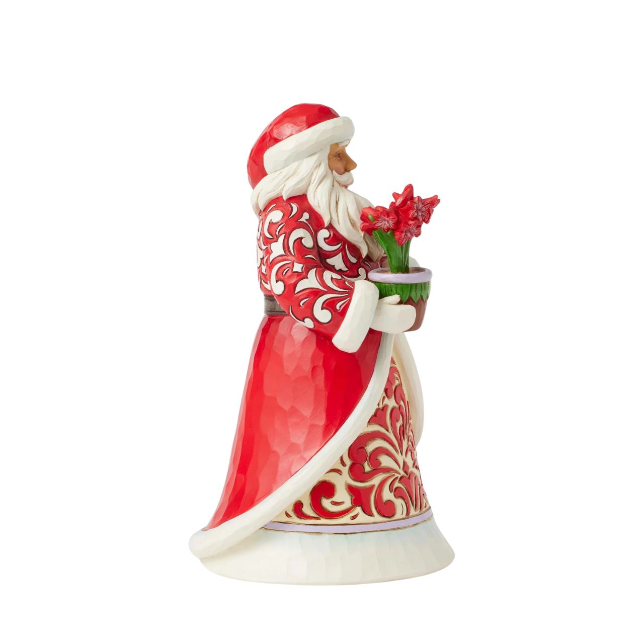 With a peaceful smile, this Jim Shore Santa holds a vase of vibrant amaryllis flowers, symbolizing the beauty and resilience of winter. His intricately patterned rosemaling coat adds a timeless touch of serenity to your holiday home décor.