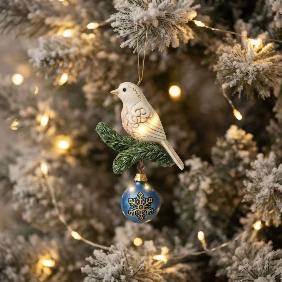 A beautiful white dove on a fir tree sprig with a gold and blue bauble makes this hanging ornament a beautiful addition to any Christmas tree.